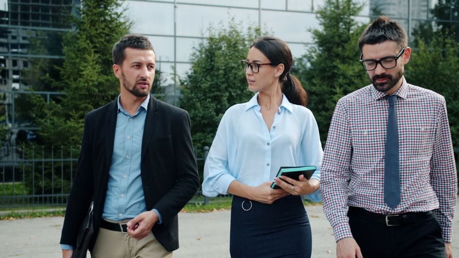 Business professionals walking together facing forward