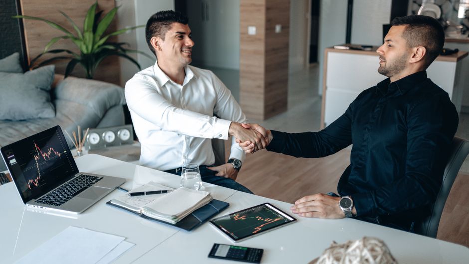 Investors shaking hands after a deal comes together